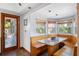 Cozy breakfast nook with booth seating and lots of light from surrounding windows at 7600 138Th St, Seminole, FL 33776