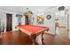A cozy game room features a red pool table, terracotta tile floor, and an adjoining opening to another room at 7600 138Th St, Seminole, FL 33776