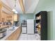Kitchen features a refrigerator, oven, sink and storage shelving for food and cookware at 7600 138Th St, Seminole, FL 33776