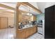 Eat-in kitchen boasts exposed wood beams, bar area, and essential appliances for a seamless cooking experience at 7600 138Th St, Seminole, FL 33776