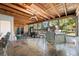 Large screened porch with a wooden ceiling, tile floor, and ample seating at 7600 138Th St, Seminole, FL 33776