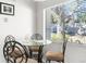 Small dining area with glass table and four chairs at 8190 Sturbridge Ct, Weeki Wachee, FL 34613