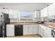 Efficient kitchen with white cabinets and black appliances at 8190 Sturbridge Ct, Weeki Wachee, FL 34613
