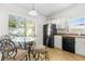 Cozy kitchen nook with glass table and four chairs at 8190 Sturbridge Ct, Weeki Wachee, FL 34613