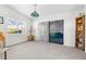 Spacious living room with sliding glass doors and bookcase at 8190 Sturbridge Ct, Weeki Wachee, FL 34613
