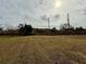 Open grassy backyard with wooden fence at 8704 Winding Wood Dr, Port Richey, FL 34668