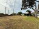 Large backyard with mature trees and grassy area at 8704 Winding Wood Dr, Port Richey, FL 34668