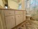 Neutral toned bathroom with a large vanity, and floral shower curtain, offering a functional space at 8704 Winding Wood Dr, Port Richey, FL 34668