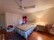 Well-lit bedroom with a double bed and dresser at 8704 Winding Wood Dr, Port Richey, FL 34668
