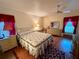 Comfortable bedroom with a double bed and wood floors at 8704 Winding Wood Dr, Port Richey, FL 34668