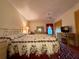 Inviting bedroom with a floral bedspread, ceiling fan, and desk; a restful retreat with functional workspace at 8704 Winding Wood Dr, Port Richey, FL 34668