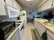 Functional kitchen featuring white cabinetry, a tiled floor and essential appliances for everyday cooking at 8704 Winding Wood Dr, Port Richey, FL 34668