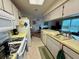 Functional kitchen featuring white cabinetry, a tiled floor and essential appliances for everyday cooking at 8704 Winding Wood Dr, Port Richey, FL 34668