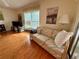 Cozy living room featuring a comfortable sofa and large window for natural light and relaxed living at 8704 Winding Wood Dr, Port Richey, FL 34668