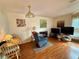 Relaxing living area with cozy seating, multiple TVs, and natural light, perfect for entertaining and unwinding at 8704 Winding Wood Dr, Port Richey, FL 34668