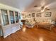 Living room with wood floors and built-in shelving at 8704 Winding Wood Dr, Port Richey, FL 34668