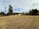 Large lot with grassy area and view of street at 8704 Winding Wood Dr, Port Richey, FL 34668