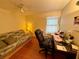 Versatile room featuring a futon and desk, offering flexibility for both relaxation and work at 8704 Winding Wood Dr, Port Richey, FL 34668