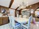 Dining area adjacent to the kitchen with a large white table and chandelier at 9481 Patrick St, Brooksville, FL 34601