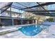 Large screened-in pool with a diving board at 9481 Patrick St, Brooksville, FL 34601