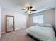 Bedroom with carpeted floor, a bed with light-colored comforter, and a large mirror at 1130 Aladdin Rd, Spring Hill, FL 34609