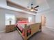 Bedroom featuring coral bedding, nightstands, and a ceiling fan at 1130 Aladdin Rd, Spring Hill, FL 34609