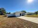 Side view of a single-Gathering home with a two-car garage at 1130 Aladdin Rd, Spring Hill, FL 34609