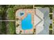 Aerial view of the community pool, clubhouse, and surrounding area at 11645 Belle Haven Dr, New Port Richey, FL 34654