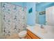 Bright bathroom with a unique shower curtain and single vanity at 11645 Belle Haven Dr, New Port Richey, FL 34654