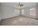Bedroom featuring carpeting and windows overlooking the neighborhood at 11645 Belle Haven Dr, New Port Richey, FL 34654