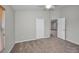 Spacious bedroom with carpet flooring and open door to another room at 11645 Belle Haven Dr, New Port Richey, FL 34654