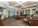 Spacious clubhouse interior with tables, chairs, and decorative accents at 11645 Belle Haven Dr, New Port Richey, FL 34654