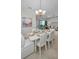Dining room with white table, chairs, and bench seating at 11645 Belle Haven Dr, New Port Richey, FL 34654