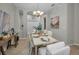 Elegant dining room featuring a decorative chandelier, neutral walls, and a formal dining set for gatherings at 11645 Belle Haven Dr, New Port Richey, FL 34654