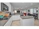 Bright kitchen with white cabinets, a kitchen island, and stainless steel appliances at 11645 Belle Haven Dr, New Port Richey, FL 34654