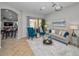 Comfortable living room with stylish furniture, a neutral color palette, and sliding doors to the outdoor space at 11645 Belle Haven Dr, New Port Richey, FL 34654