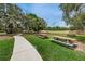 Community park with picnic tables, walking paths, and large oak trees at 11645 Belle Haven Dr, New Port Richey, FL 34654
