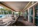 Covered patio with seating overlooking the community pool at 11645 Belle Haven Dr, New Port Richey, FL 34654