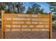 Wooden sign dedicating the park to U.S. armed forces veterans at 11645 Belle Haven Dr, New Port Richey, FL 34654