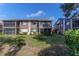 Rear view of condo showing patio and lawn at 12814 Wedgewood Way # C, Hudson, FL 34667