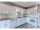 Updated kitchen boasting white cabinets, granite countertops, and white appliances at 12814 Wedgewood Way # C, Hudson, FL 34667