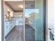 Kitchen with balcony access and white appliances at 12814 Wedgewood Way # C, Hudson, FL 34667