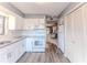Bright kitchen featuring white cabinets, granite countertops, and modern appliances at 12814 Wedgewood Way # C, Hudson, FL 34667