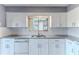 Modern kitchen with white cabinets, granite countertops and stainless steel appliances at 12814 Wedgewood Way # C, Hudson, FL 34667