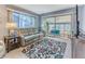 Living room with access to screened patio and comfy seating at 12814 Wedgewood Way # C, Hudson, FL 34667