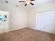 Bedroom with ceiling fan and door to bathroom at 13836 Newport Shores Dr, Hudson, FL 34669