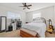 Bright bedroom with a queen-size bed, desk, and ample closet space at 1409 Meredith Dr, Spring Hill, FL 34608