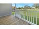 Wooden deck overlooking a grassy backyard with trees and a view of a golf course at 14287 Rialto Ave, Brooksville, FL 34613