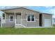 Front view of a tan home with attached carport and white accents at 14287 Rialto Ave, Brooksville, FL 34613