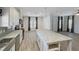 Modern kitchen with white cabinets, an island with granite countertops, and stainless steel appliances at 14287 Rialto Ave, Brooksville, FL 34613